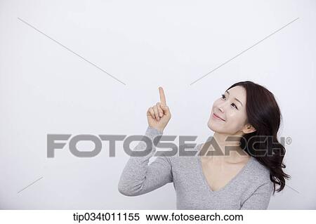 a woman in grey plain shirt smiling View Large Photo Image Stock Photography - a woman in grey plain shirt smiling. Fotosearch