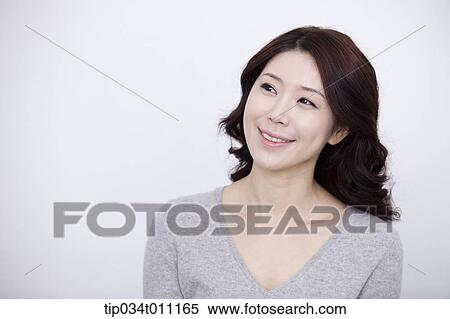 a woman in grey plain shirt smiling View Large Photo Image Stock Photography - a woman in grey plain shirt smiling. Fotosearch