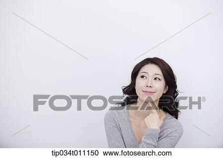 a woman in grey plain shirt thinking View Large Photo Image Stock Image - a woman in grey plain shirt thinking. Fotosearch
