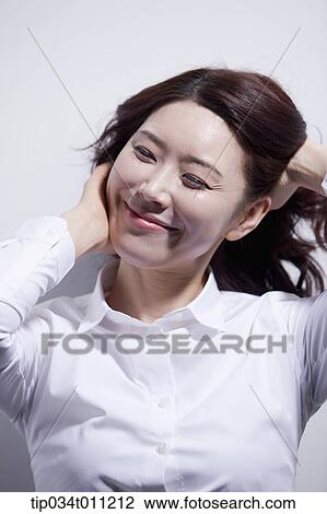 a woman in white shirt enjoying the sun light View Large Photo Image Stock Image - a woman in white shirt enjoying the sun light. Fotosearch