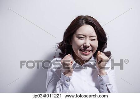 Stock Image - a woman in white shirt smiling. Fotosearch