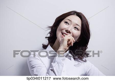a woman in white shirt smiling View Large Photo Image Stock Photo - a woman in white shirt smiling. Fotosearch