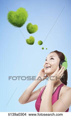 a woman listening to music View Large Photo Image Picture - a woman listening to music. Fotosearch