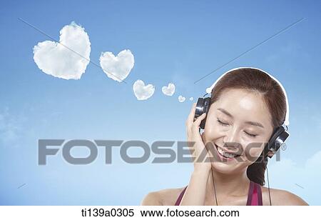 a woman listening to music View Large Photo Image Stock Photography - a woman listening to music. Fotosearch