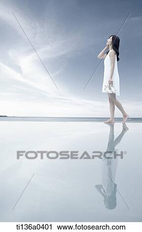 a woman looking at the sky View Large Photo Image Stock Image - a woman looking at the sky. Fotosearch