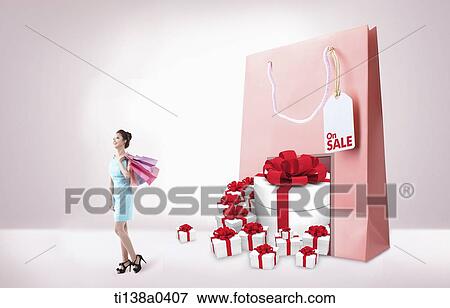 a woman next to a shopping bag and presents View Large Photo Image Stock Photo - a woman next to a shopping bag and presents. Fotosearch