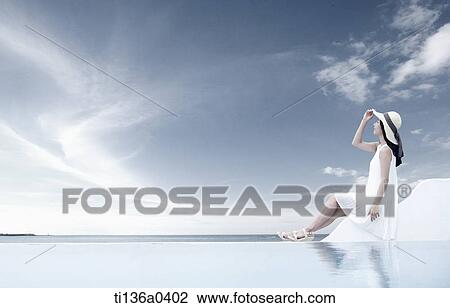 a woman sitting and looking at the sky View Large Photo Image Stock Image - a woman sitting and looking at the sky. Fotosearch