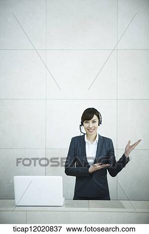 Stock Photo - a woman standing in the reception. Fotosearch