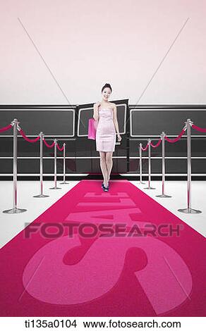 Picture - a woman standing on red carpet saying sale. Fotosearch