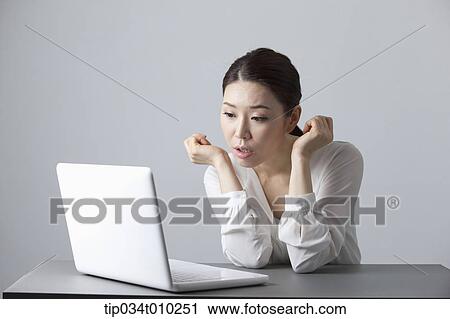 a woman surprised while using a laptop View Large Photo Image Stock Image - a woman surprised while using a laptop. Fotosearch