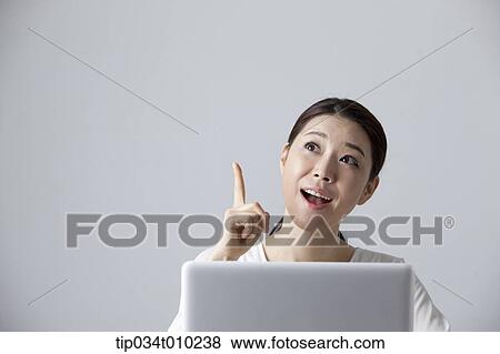 a woman thinking while using a laptop View Large Photo Image Stock Photo - a woman thinking while using a laptop. Fotosearch
