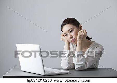 Stock Image - a woman using a laptop. Fotosearch