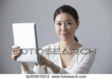 a woman using a tablet PC View Large Photo Image Stock Image - a woman using a tablet PC . Fotosearch