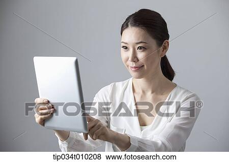 a woman using a tablet PC View Large Photo Image Stock Photo - a woman using a tablet PC . Fotosearch