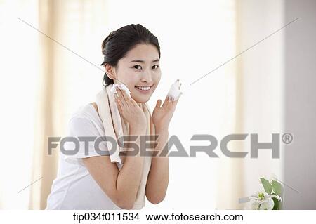 Picture - a woman washing her face. Fotosearch