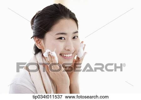 Stock Photo - a woman washing her face. Fotosearch