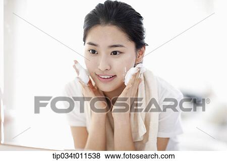 Stock Photo - a woman washing her face. Fotosearch