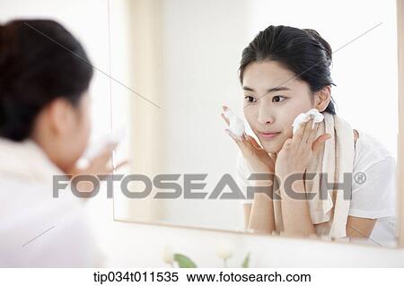 a woman washing her face View Large Photo Image Stock Photography - a woman washing her face. Fotosearch