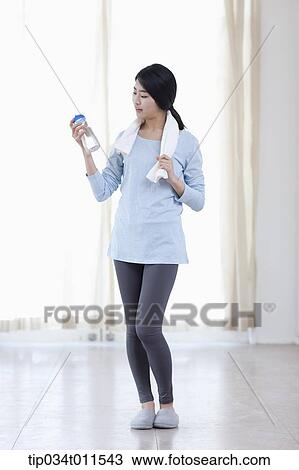 Stock Image - a woman with a bottle of water. Fotosearch
