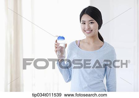 Stock Photo - a woman with a bottle of water. Fotosearch