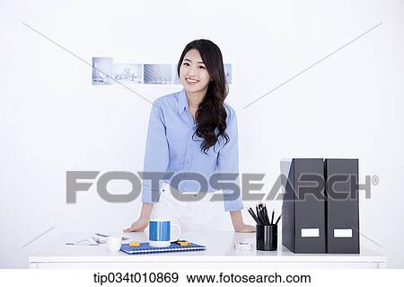 Stock Photo - an interior designer at her desk. Fotosearch