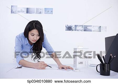an interior designer at her desk with a model house View Large Photo Image Stock Image - an interior designer at her desk with a model house. Fotosearch