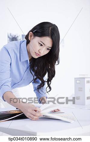 Stock Image - an interior designer looking at colour scales. Fotosearch