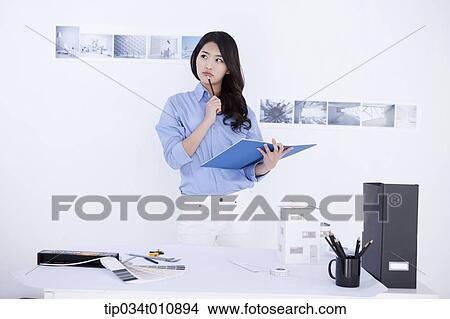 Picture - an interior designer with a sketch book. Fotosearch