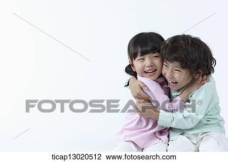 Stock Image - brother and sister hugging. Fotosearch