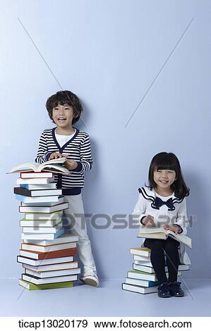 Stock Photo - brother and sister reading books. Fotosearch
