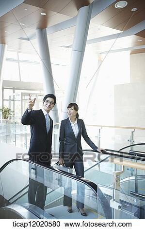 Stock Image - business people going up the stairs. Fotosearch