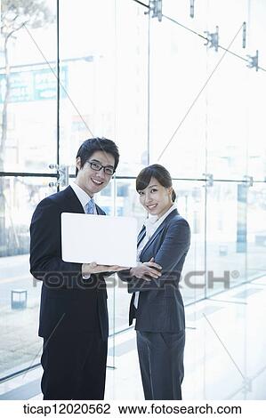 business people looking at a laptop View Large Photo Image Stock Image - business people looking at a laptop. Fotosearch