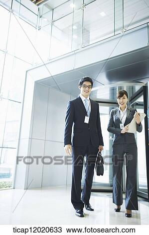 Stock Image - business people standing in the door way. Fotosearch