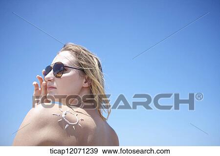 Stock Photo - close up back shot of a lady in bikini in the beach. Fotosearch