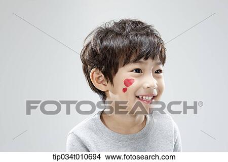 Picture - close up of a boy with face paint smiling. Fotosearch