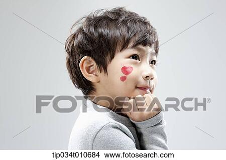 Picture - close up of a boy with face paint posing. Fotosearch