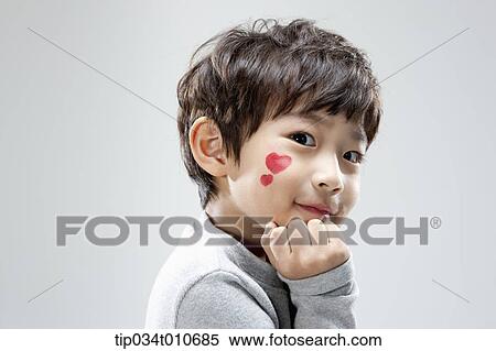 Stock Photography - close up of a boy with face paint posing. Fotosearch