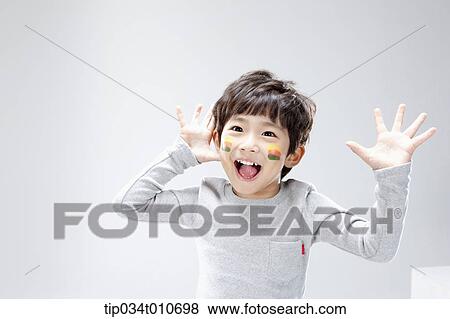 Stock Photo - close up of a boy with face paint playing. Fotosearch