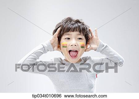 Stock Photograph - close up of a boy with face paint playing. Fotosearch
