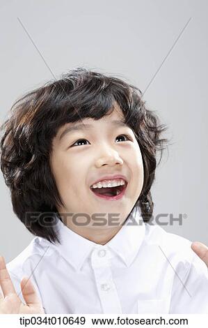 close up of a boy with white shirt looking happy View Large Photo Image Stock Photo - close up of a boy with white shirt looking happy. Fotosearch