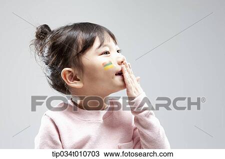 Stock Image - close up of a girl with face paint playing. Fotosearch