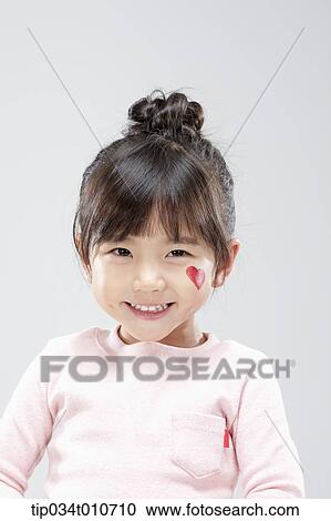 Stock Image - close up of a girl with face paint smiling. Fotosearch