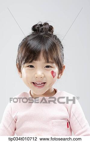 Stock Image - close up of a girl with face paint smiling. Fotosearch