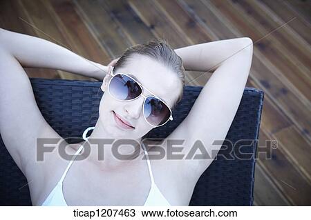 close up of a lady in bikini and sunglasses View Large Photo Image Stock Image - close up of a lady in bikini and sunglasses. Fotosearch