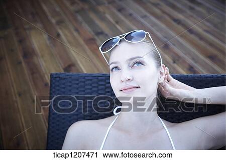 Stock Image - close up of a lady in bikini and sunglasses. Fotosearch