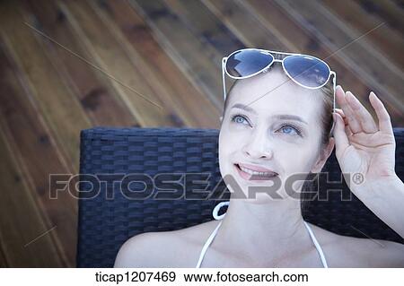 Stock Photo - close up of a lady in bikini and sunglasses. Fotosearch