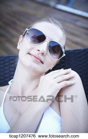Stock Photograph - close up of a lady in bikini and sunglasses. Fotosearch