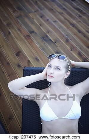 Stock Photography - close up of a lady in bikini and sunglasses. Fotosearch