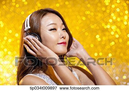 close up of a woman in fancy dress listening to music with headphone View Large Photo Image Stock Photo - close up of a woman in fancy dress listening to music with headphone. Fotosearch
