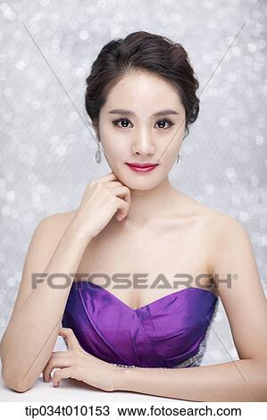 close up of a woman in purple dress posing gracefully View Large Photo Image Stock Image - close up of a woman in purple dress posing gracefully . Fotosearch
